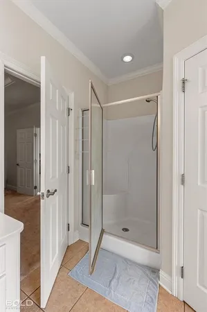 a bathroom with a glass shower door