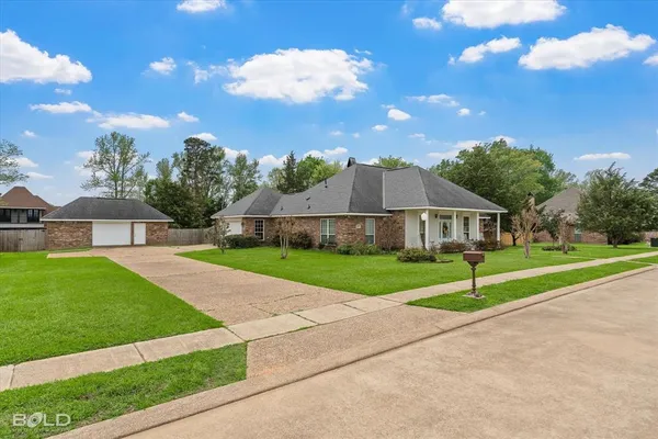 a front view of house with yard and green space