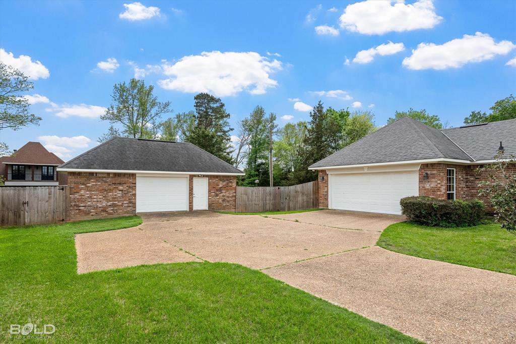 129 Wax Wing Drive Stonewall, LA 71078 - Photo 6 of 40 a front view of a house with a yard and garage