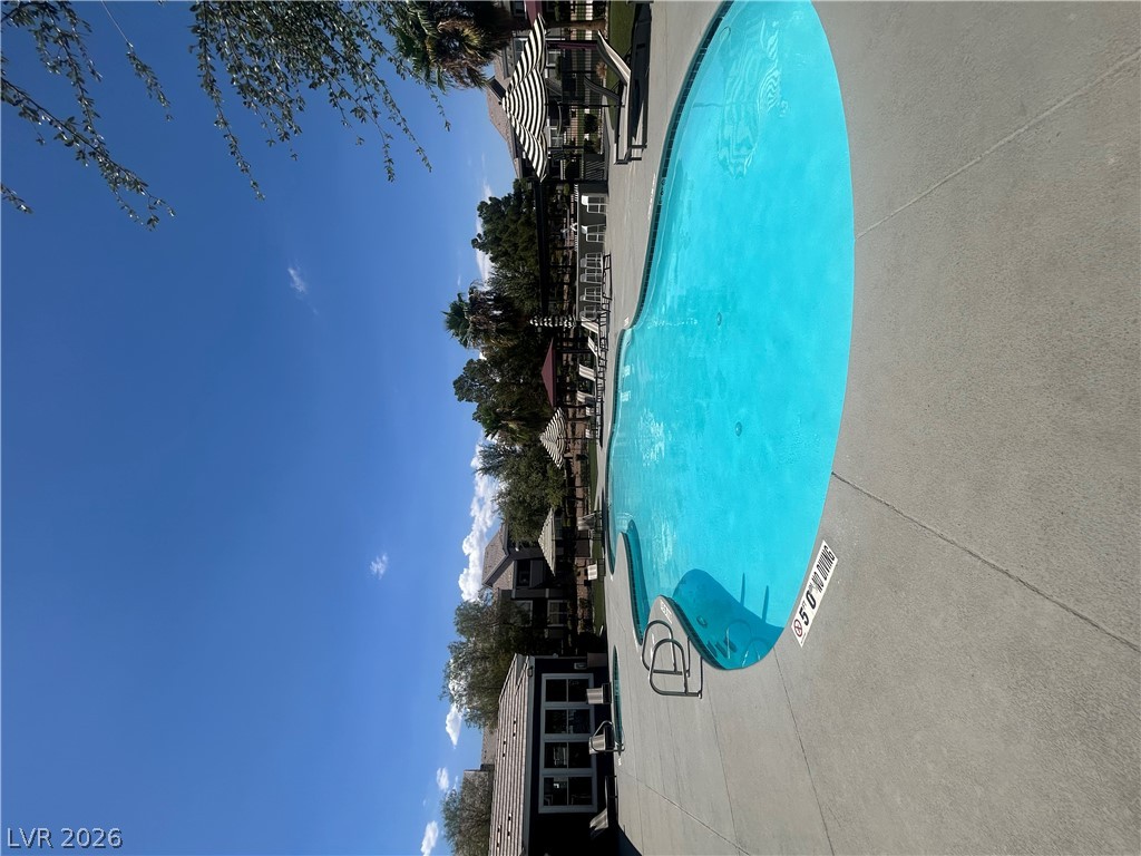 9620 West Russell Road, Unit 1010 Las Vegas, NV 89148 - Photo 9 of 9 An inviting community pool with ample decking awaits for relaxing and recreation.