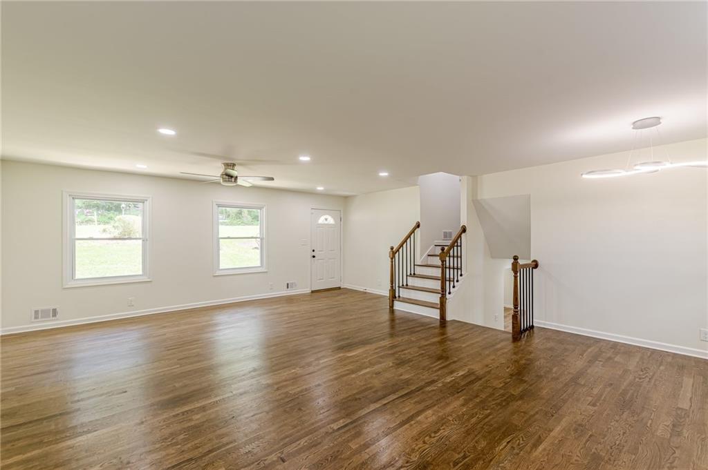 3275 Clifton Church Road Southeast Atlanta, GA 30316 - Photo 15 of 59 an empty room with wooden floor and windows