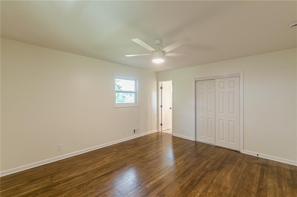 3275 Clifton Church Road Southeast Atlanta, GA 30316 - Photo 30 of 59 an empty room with wooden floor and windows