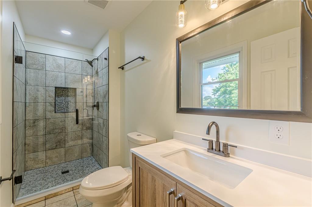 3275 Clifton Church Road Southeast Atlanta, GA 30316 - Photo 33 of 59 a bathroom with a sink toilet vanity and shower