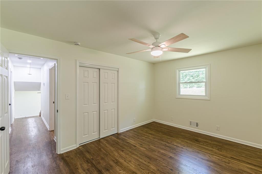 3275 Clifton Church Road Southeast Atlanta, GA 30316 - Photo 38 of 59 a view of a room with wooden floor and a ceiling fan
