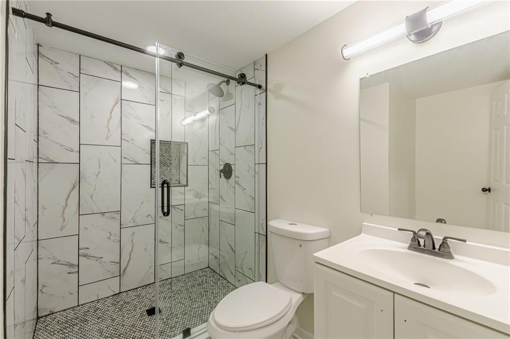 3275 Clifton Church Road Southeast Atlanta, GA 30316 - Photo 46 of 59 a bathroom with a sink toilet and shower