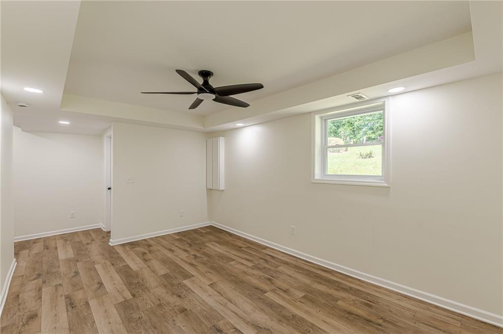 3275 Clifton Church Road Southeast Atlanta, GA 30316 - Photo 48 of 59 a view of a big room with wooden floor and a ceiling fan