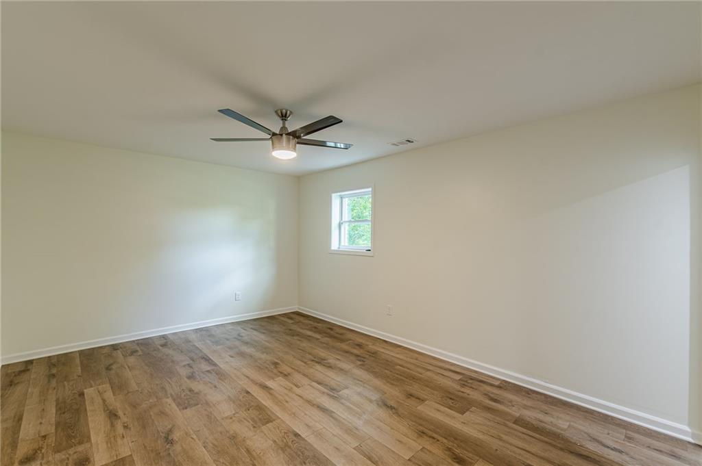 3275 Clifton Church Road Southeast Atlanta, GA 30316 - Photo 50 of 59 an empty room with a window and a fan