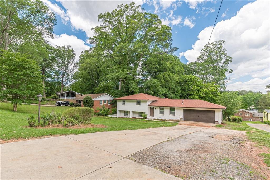 3275 Clifton Church Road Southeast Atlanta, GA 30316 - Photo 5 of 59 a front view of a house with a yard and garage