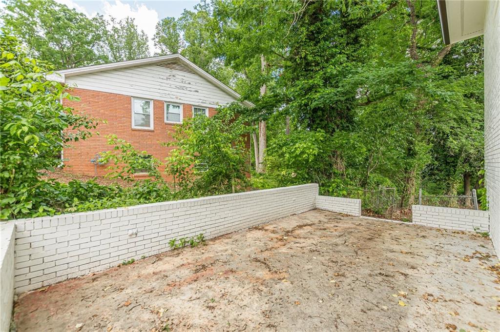 3275 Clifton Church Road Southeast Atlanta, GA 30316 - Photo 8 of 59 a view of a house with a yard and large tree