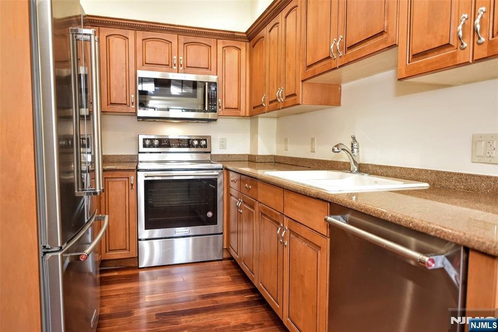 4201 Rio Vista Drive, Unit 4201 Mahwah, NJ 07430 - Photo 10 of 34 a kitchen with stainless steel appliances granite countertop a stove a sink and a microwave