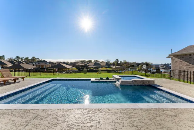 a view of swimming pool with outdoor seating and yard in back