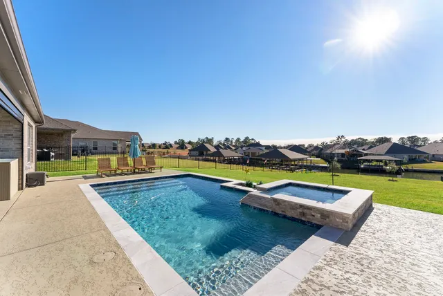 swimming pool with outdoor seating and yard