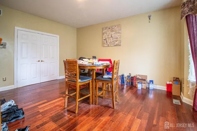 a dining room with furniture and wooden floor