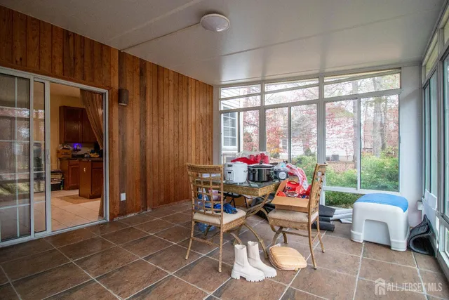 a living room filled with furniture and a potted plant