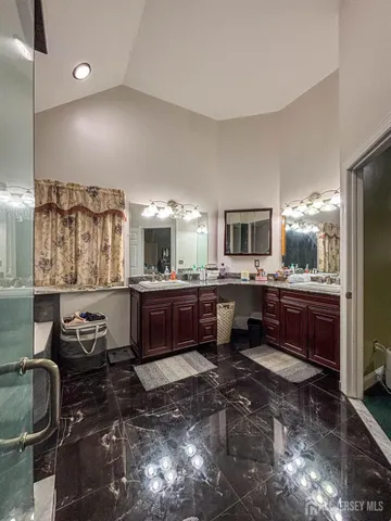 a large bathroom with a large mirror vanity and sink