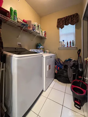 a view of a patio with table and chairs and wooden fence