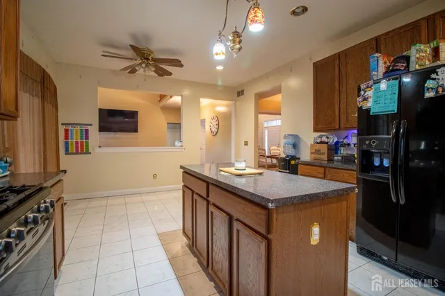 a kitchen with stainless steel appliances granite countertop a sink and a stove