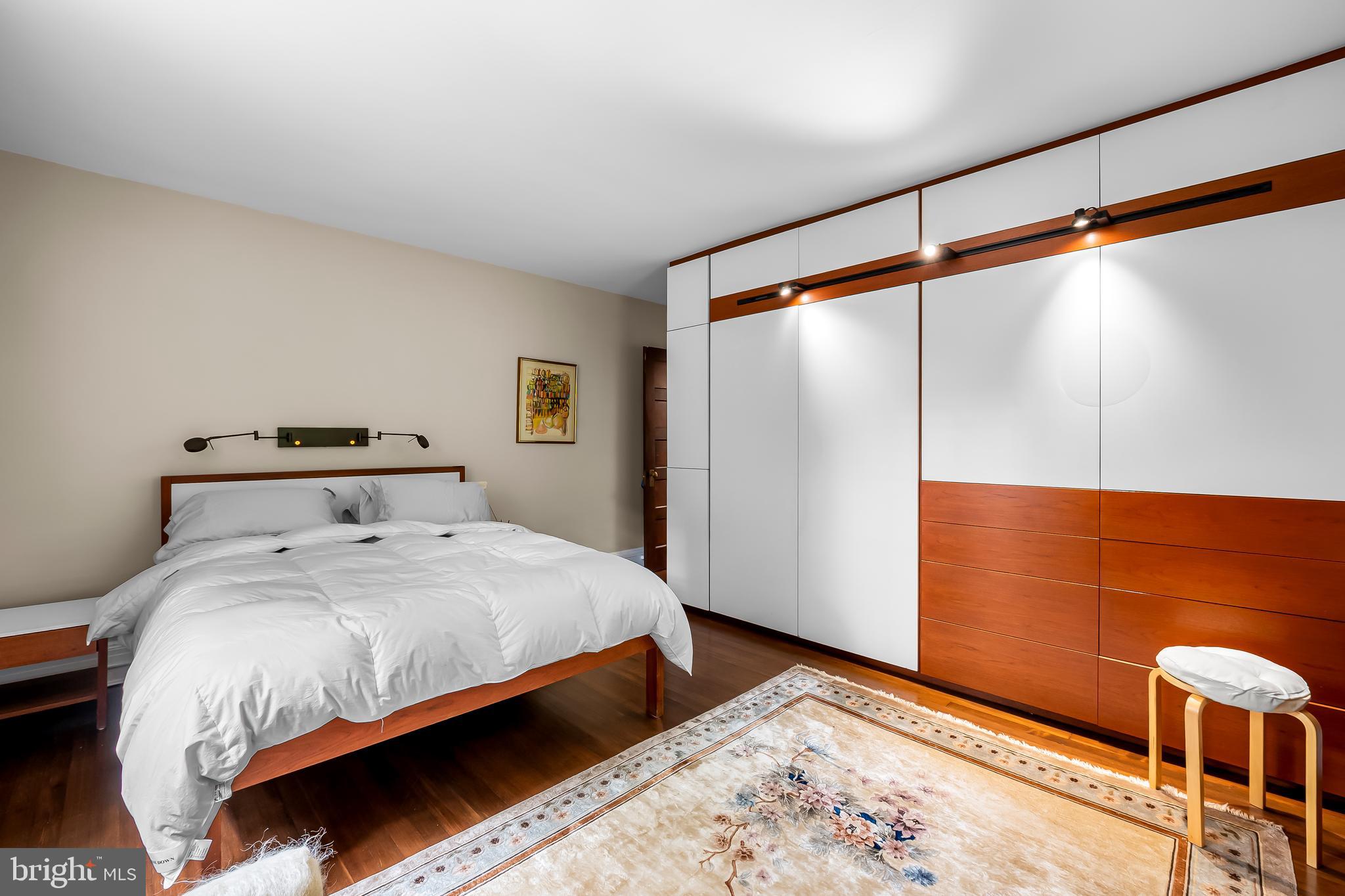 111 Deepdene Road Baltimore, MD 21210 - Photo 35 of 61 a bedroom with a bed and a dresser with wooden floor