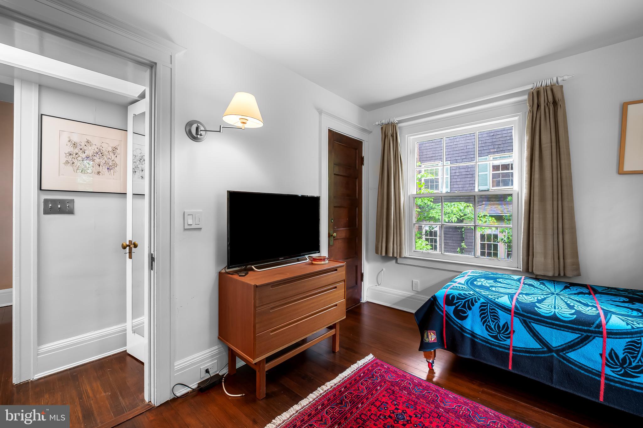 111 Deepdene Road Baltimore, MD 21210 - Photo 39 of 61 a bedroom with a bed and wooden floor