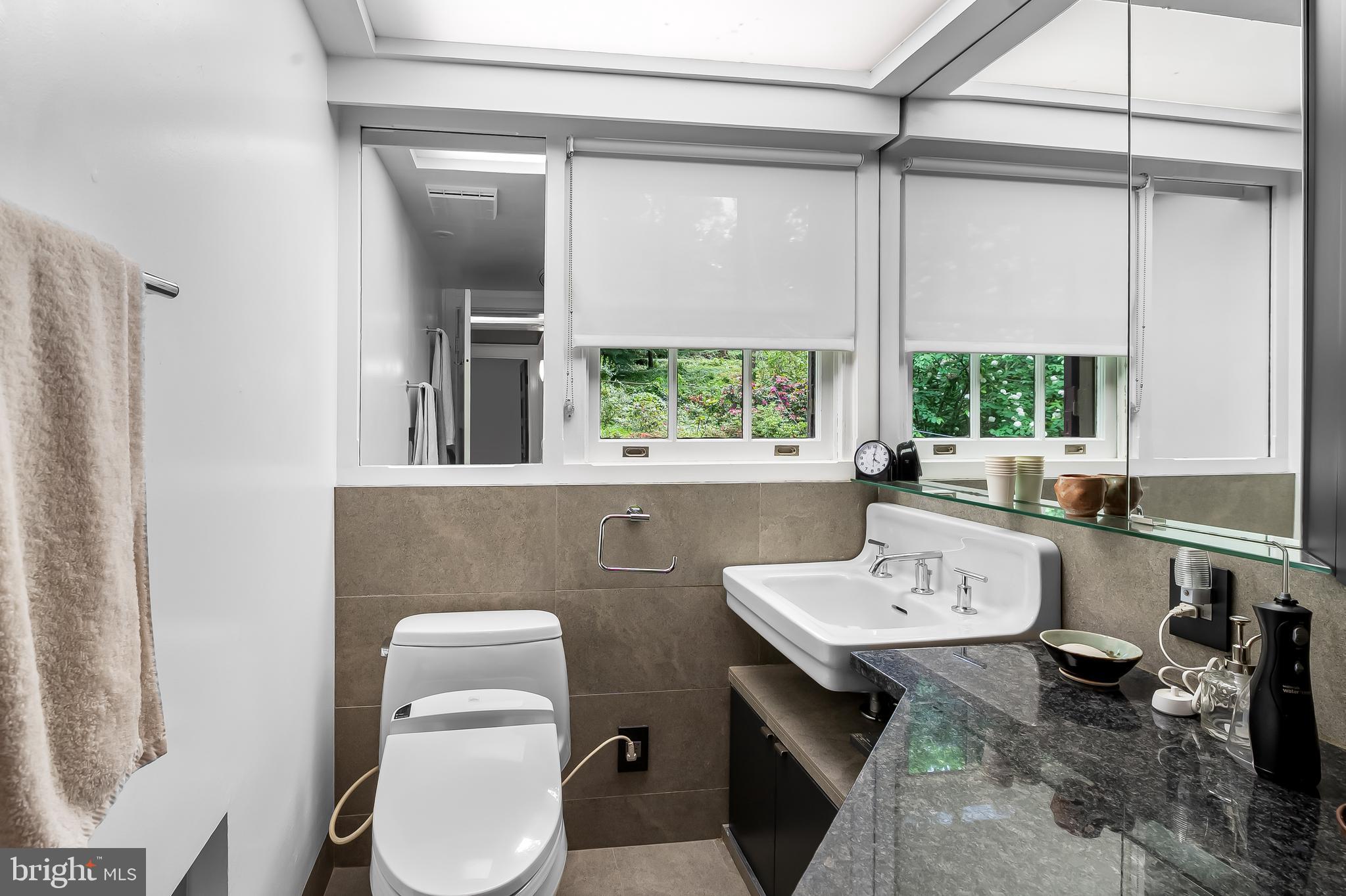 111 Deepdene Road Baltimore, MD 21210 - Photo 43 of 61 a bathroom with a sink a toilet and a window