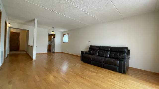 a living room with a couch and a ceiling fan