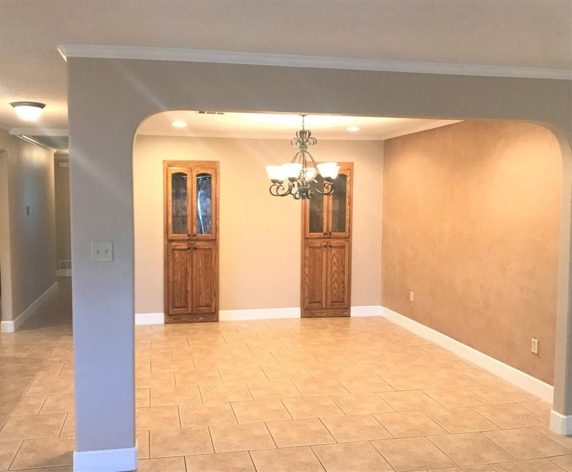 305 Ranch Street Ropesville, TX 79358 - Photo 5 of 10 a view of a hallway with wooden floor and a chandelier
