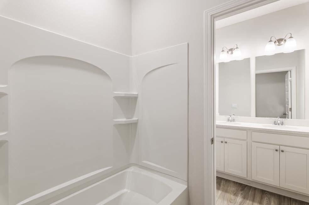 44 Oak Trees Lane West Freeport, FL 32439 - Photo 19 of 23 a bathroom with a bathtub sink vanity and mirror