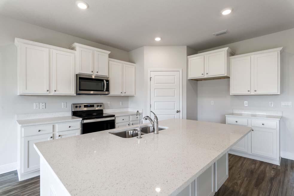 44 Oak Trees Lane West Freeport, FL 32439 - Photo 6 of 23 a kitchen with stainless steel appliances a stove a sink a microwave and cabinets
