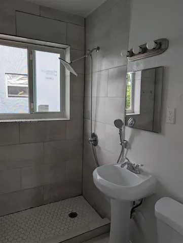 a bathroom with a sink toilet and shower