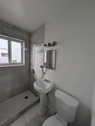 a bathroom with a toilet sink and shower