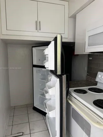 a kitchen with a stove and a refrigerator