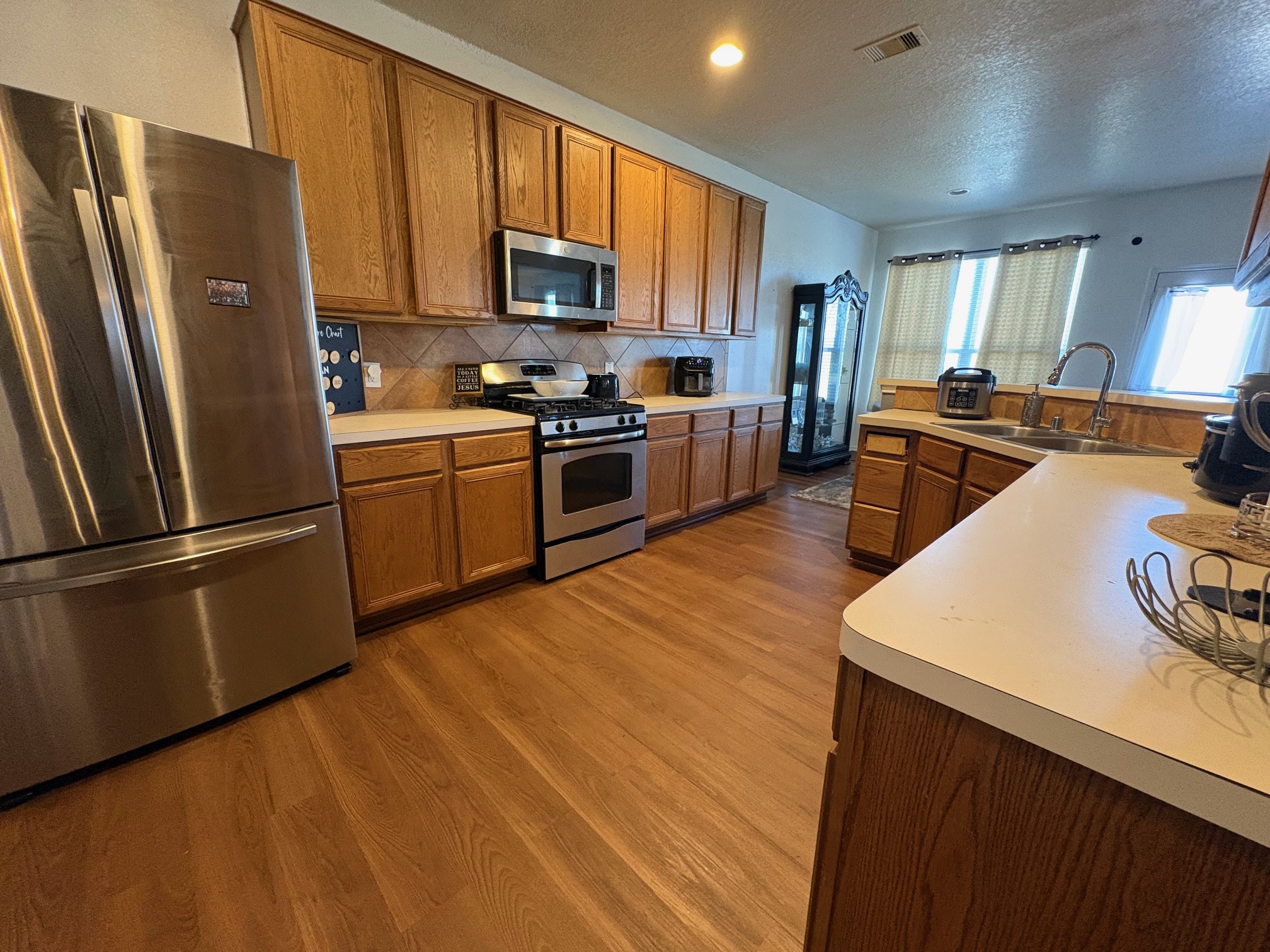 5915 Annatto Drive Baytown, TX 77521 - Photo 11 of 31 a kitchen with stainless steel appliances a refrigerator stove microwave and sink