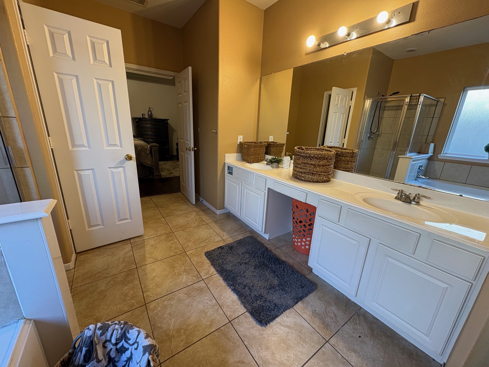 5915 Annatto Drive Baytown, TX 77521 - Photo 22 of 31 a spacious bathroom with a double vanity sink a mirror and a shower