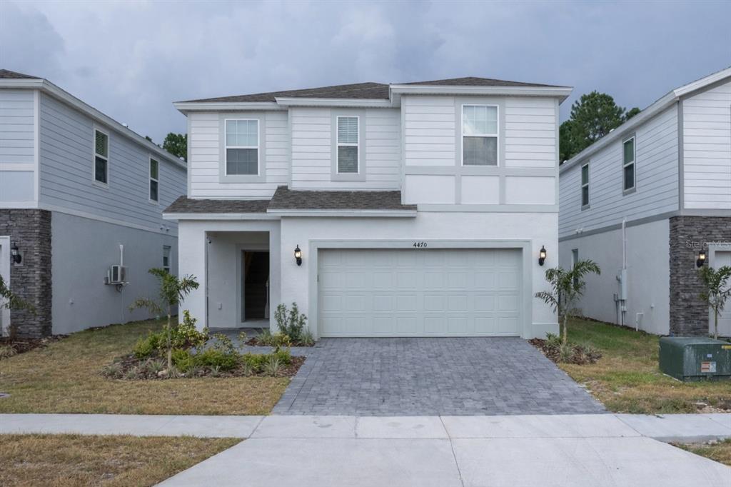 4470 Kaipo Road Davenport, FL 33897 - Photo 1 of 34 a front view of a house with garden