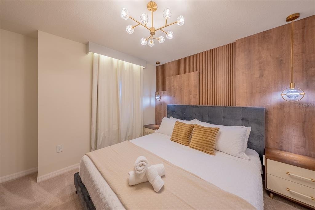 4470 Kaipo Road Davenport, FL 33897 - Photo 16 of 34 a bedroom with a bed and a ceiling fan