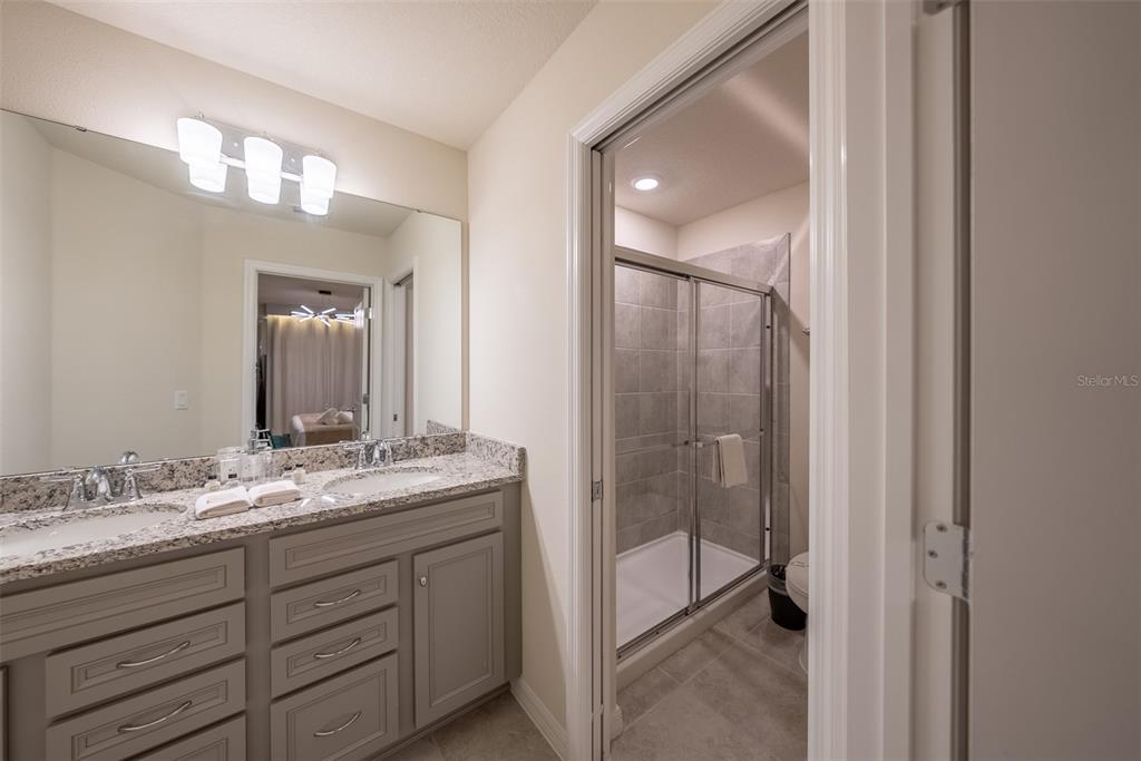4470 Kaipo Road Davenport, FL 33897 - Photo 18 of 34 a bathroom with a sink double vanity and a mirror