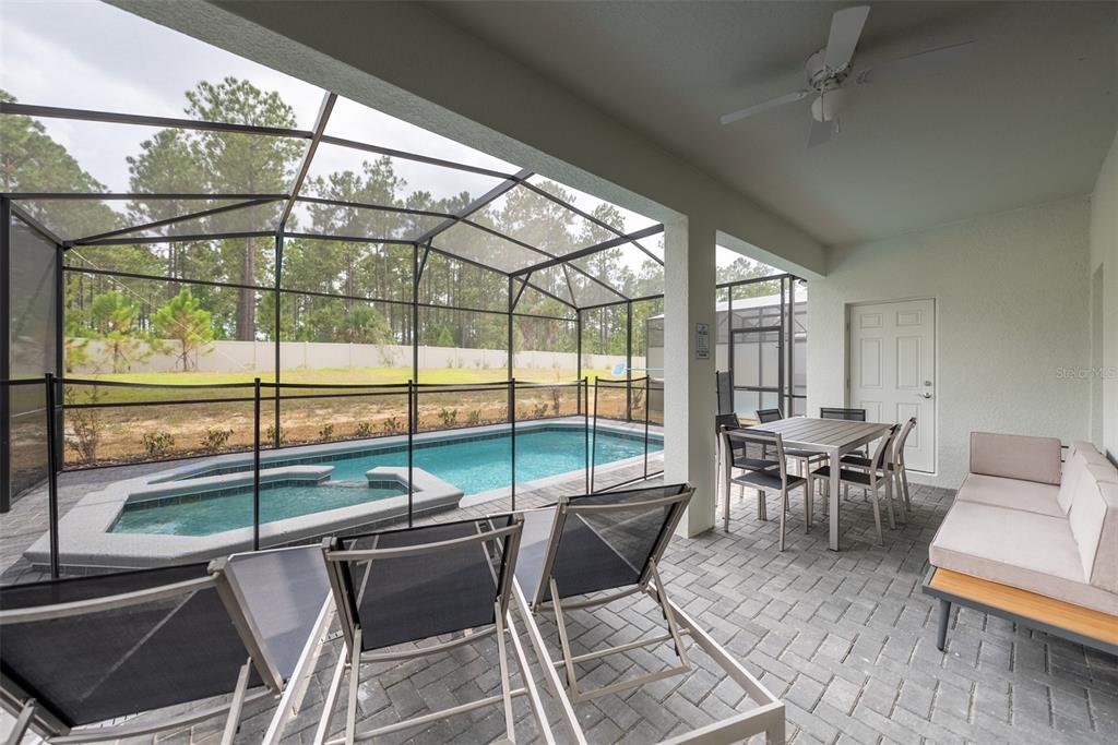 4470 Kaipo Road Davenport, FL 33897 - Photo 33 of 34 a living room with furniture and a floor to ceiling window