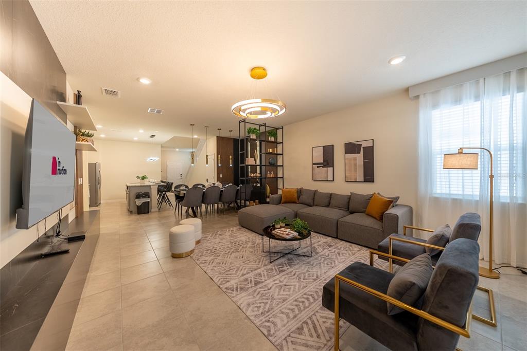 4470 Kaipo Road Davenport, FL 33897 - Photo 5 of 34 a living room with furniture and a flat screen tv