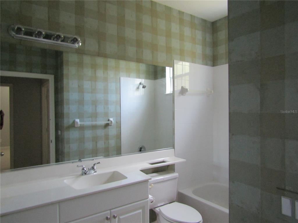 1669 Monarch Drive, Unit 204 Venice, FL 34293 - Photo 14 of 17 a bathroom with a sink toilet and shower