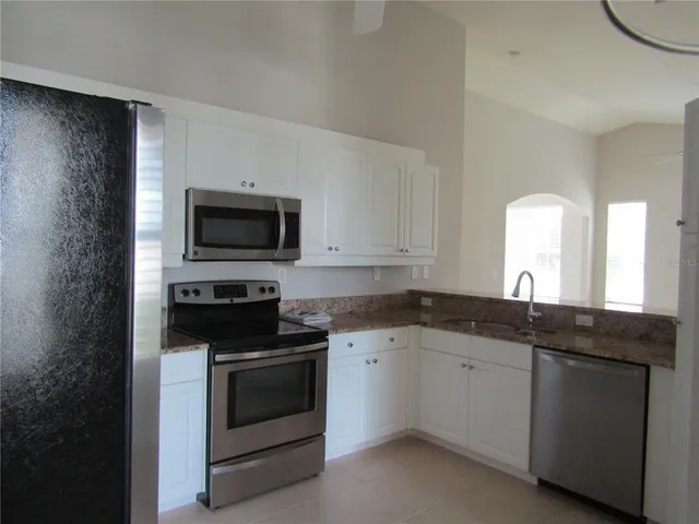 a kitchen with a sink stove and microwave