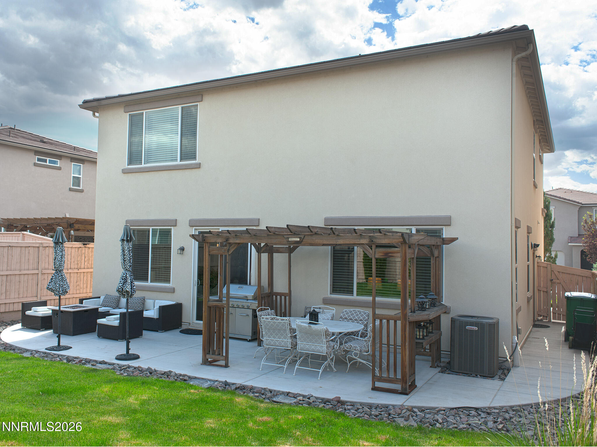9766 Pachuca Drive Reno, NV 89521 - Photo 52 of 59 a view of a patio with table and chairs barbeque potted plants and large tree