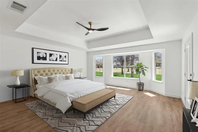 a spacious bedroom with a large bed and a large window