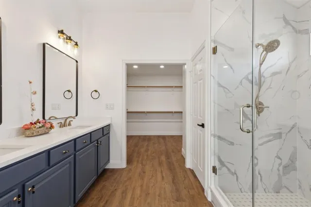 a bathroom with a double vanity sink and mirror