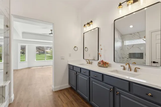 a bathroom with a double vanity sink and a mirror