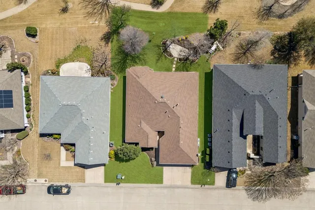 aerial view of a house with a yard and potted plants