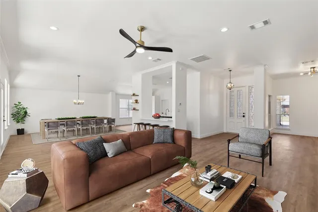 a living room with furniture a rug and white walls