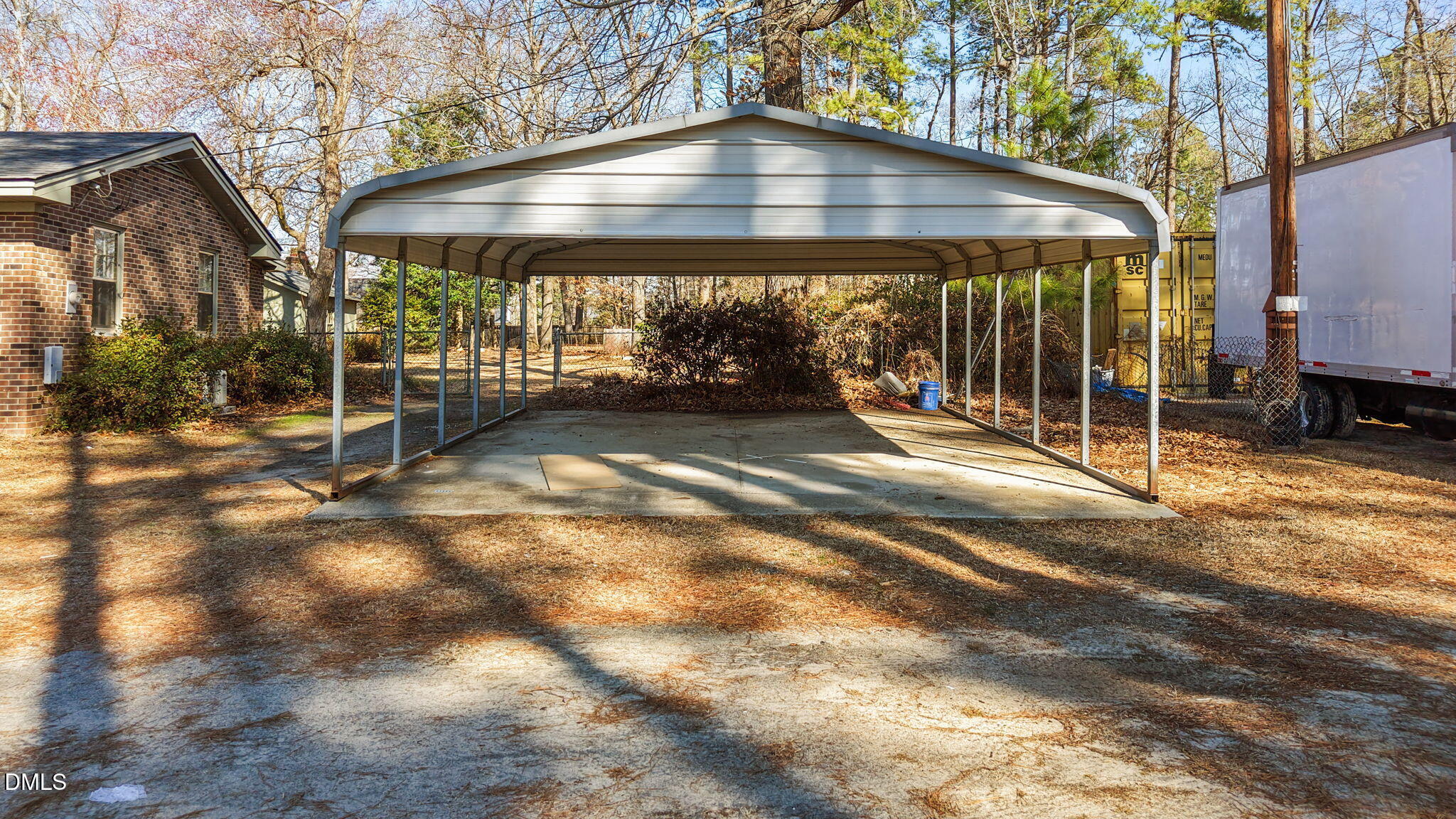 3738 Red Oak Battleboro Road Battleboro, NC 27809 - Photo 38 of 53 a view of a patio with a table and chairs under an umbrella