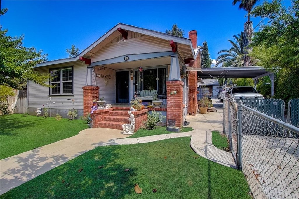 59 Roosevelt Road Banning, CA 92220 - Photo 1 of 1 a front view of a house with a yard table and chairs