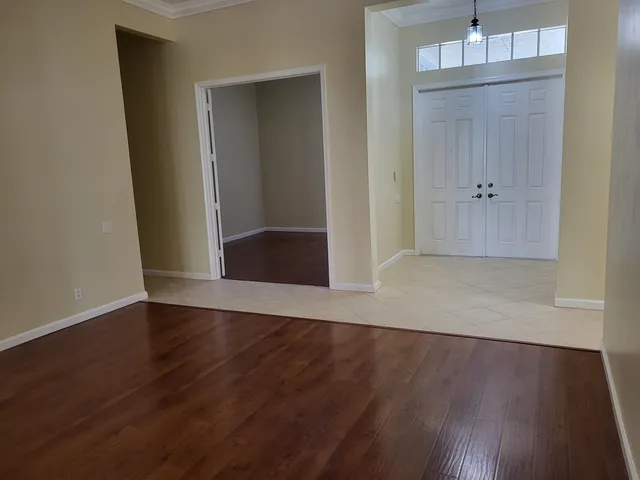 an empty room with wooden floor and closet
