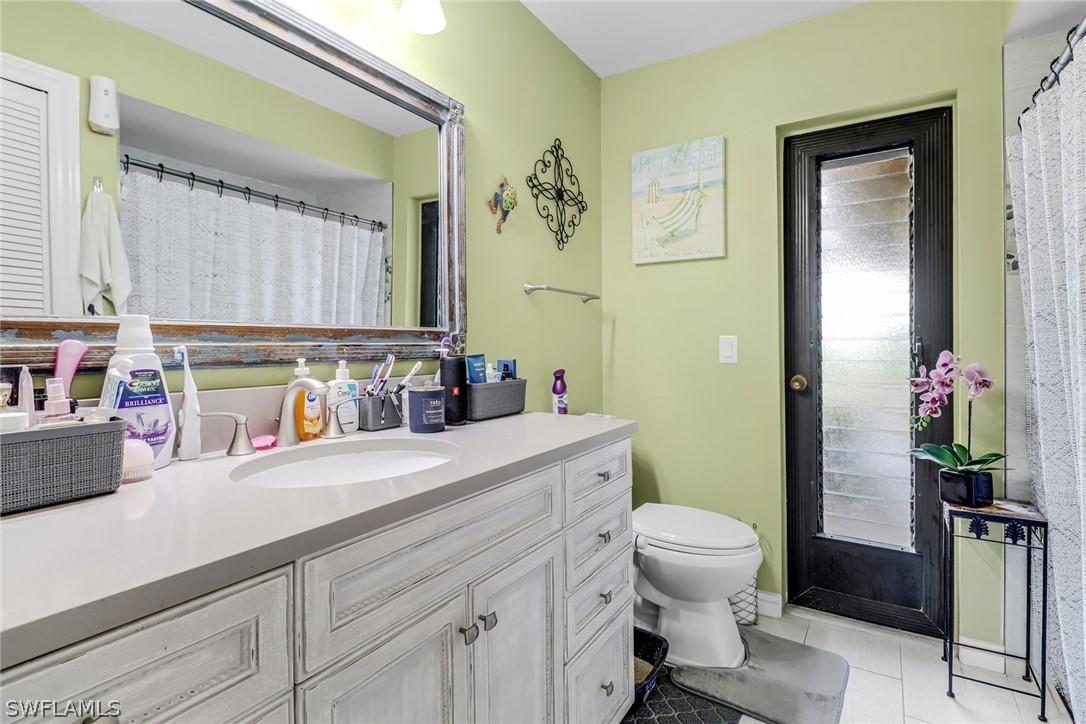 7523 Morgan Road Fort Myers, FL 33967 - Photo 17 of 25 a bathroom with a sink a toilet and mirror
